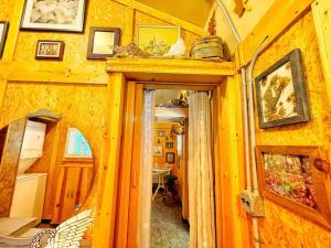 a hallway of a house with a room with a mirror at Tiny House, WIFI,Hot tub,Secluded in Cosby