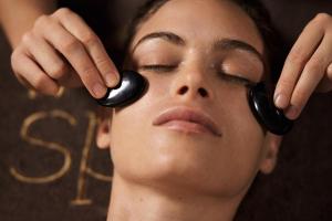 a woman with black headphones on her eyes at Grand Tonic Hotel & SPA NUXE in Biarritz