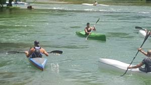 a group of people in kayaks on a river at Apartman Insula in Otoka