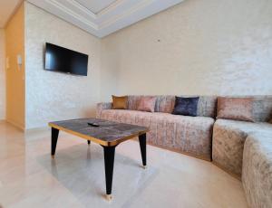 een woonkamer met een bank en een salontafel bij Appartment in Tanger City Center - 5min to The Beach - Free Parking in Tanger