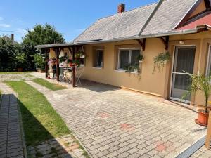 a house with a brick driveway in front of it at Zsigmond Vendeghaz in Keszthely