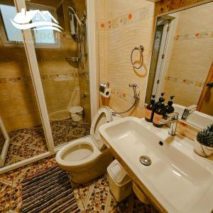 a bathroom with a toilet and a sink at Mirador Old-Time House walking distance to Lourdes Grotto in Baguio +31 photos