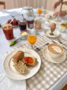 a table with a plate with bread and a cup of coffee at Entre les branches in Saint-Règle