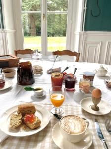 a table with a breakfast of eggs bread and coffee at Entre les branches in Saint-Règle +39 photos
