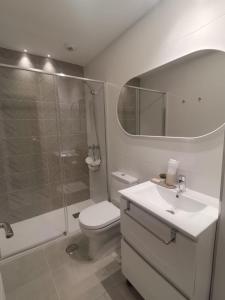 a bathroom with a shower and a toilet and a sink at Playa & Golf Deluxe en Playa Granada in Motril