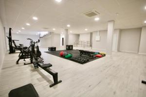 a gym with treadmills and exercise bikes in a room at Playa & Golf Deluxe en Playa Granada in Motril