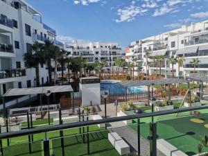 a view of an apartment complex with a golf course at Playa & Golf Deluxe en Playa Granada in Motril