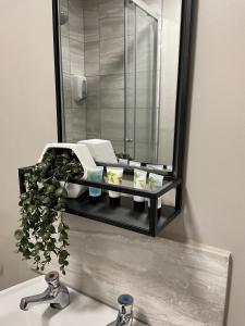 a bathroom sink with a mirror above a sink at The Mitre Hotel in Manchester