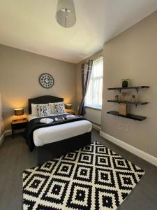 a bedroom with a bed and a rug at The Mitre Hotel in Manchester
