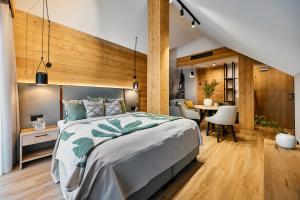 a bedroom with a large bed and a desk at Tatra Nest Apartamenty in Biały Dunajec