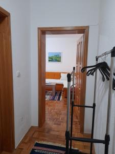 a hallway with a room with a bed and a treadmill at Apartman Insula in Otoka