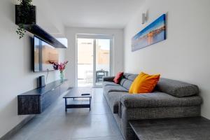 a living room with a couch and a table at Central Sliema 3-Bedroom Retreat in Sliema