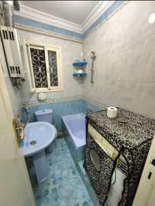 a bathroom with a sink and a toilet and a tub at Family friendly 3 bedrooms apartment for rent in Hadayek El Maadi. in Cairo