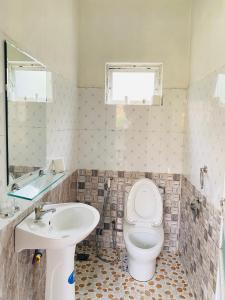 a bathroom with a toilet and a sink at Thai Culture Homestay in Mù Cang Chải