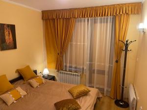 a bedroom with a large bed and a window at Ski-in ski-out Fantastic Apartament in Bansko