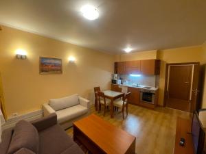 a living room with a couch and a table at Ski-in ski-out Fantastic Apartament in Bansko