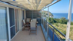 a balcony with a table and chairs and the ocean at Sunny House in Byala