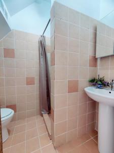 a bathroom with a toilet and a sink at Corfu sea view house - Live in Corfu like a local! in Ágios Márkos