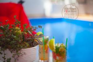 a table with two vases filled with plants and a sign at Old Town Point Hotel & Spa Antalya in Antalya