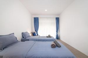 a bedroom with two beds and a window at Sunset Family House in Bibinje on the Beach in Bibinje