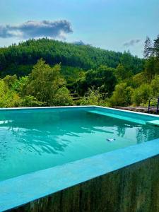 a swimming pool with a view of a mountain at Giant Canvas Rental Tent Agro-turismo Quinta da Fonte in Figueiró dos Vinhos