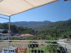 a view of the mountains from the balcony of a house at Blue House in Mugla