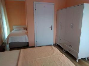 a bedroom with a bed and a large white cabinet at Blue House in Mugla