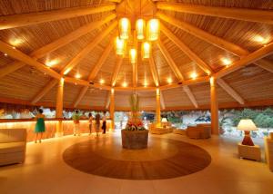 a large lobby with a large wooden ceiling with lights at Bluewater Maribago Beach Resort in Mactan