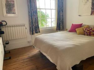 a bedroom with a large bed and a window at Artistic spacious flat in central Brixton in London