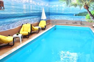 a swimming pool with a view of the ocean at Old Town Point Hotel & Spa Antalya in Antalya