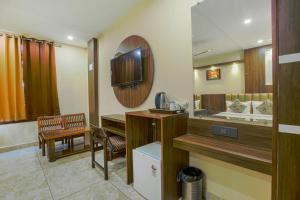 a room with a bathroom with a sink and a mirror at Hotel Crown, Amritsar in Amritsar