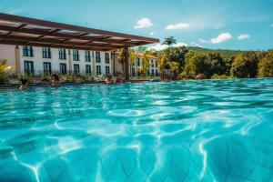 una piscina en un hotel con agua azul en Quinta Santa Bárbara Pirenópolis, en Pirenópolis