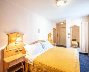 Ένα ή περισσότερα κρεβάτια σε δωμάτιο στο Hotel Relais Orsingher