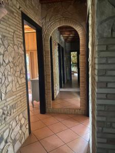 a hallway with two mirrors on a brick wall at Villa Paola in Villa San Leonardo