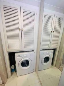 a laundry room with a washing machine and a washer at Rancho Miraflores Seaview Studio in La Cala de Mijas