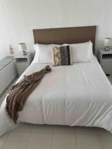 a large white bed with white sheets and pillows at Rancho Miraflores Seaview Studio in La Cala de Mijas