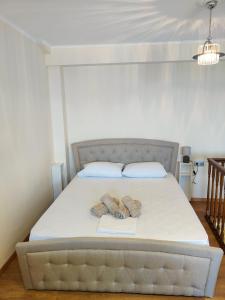 a bed with two pillows and two books on it at Corfu sea view house - Live in Corfu like a local! in Ágios Márkos