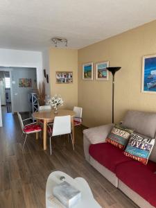 a living room with a couch and a table at Apt. New Holiday Valencia Beach in El Puig