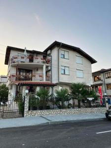 a large building with a fence in front of it at Ianakiev Guest House in Chernomorets