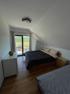 a bedroom with two beds and a window at Cabana Sunrise in Beclean +18 photos
