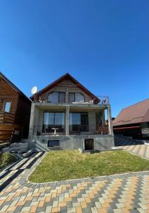 a large house with a balcony on the front of it at Cabana Sunrise in Beclean