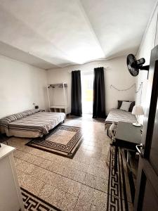 a bedroom with two beds in a room with a window at I Ninni in Castiglione del Lago