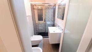 a bathroom with a toilet and a sink and a shower at Socrate Suite in Messina