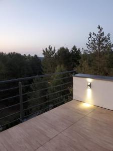 a light sitting on the edge of a deck at LUX Apartman Simi in Divčibare