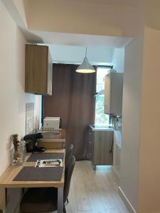 a small kitchen with a table and a counter top at Blue Bike Residence Mamaia Studio in Mamaia