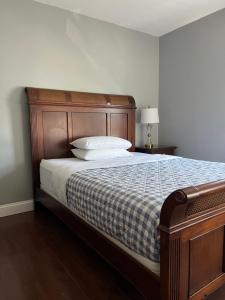 a bedroom with a bed with a blue and white blanket at Airport room 33 in Boston