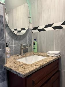 a bathroom with a sink and a mirror at Airport room 33 in Boston +3 photos