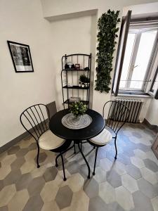 a dining room with a black table and chairs at I Ninni in Castiglione del Lago