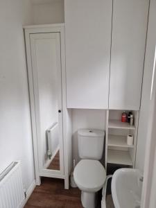 a small bathroom with a toilet and a sink at Private room in Manchester