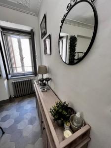 a bathroom with a mirror on the wall and a sink at I Ninni in Castiglione del Lago